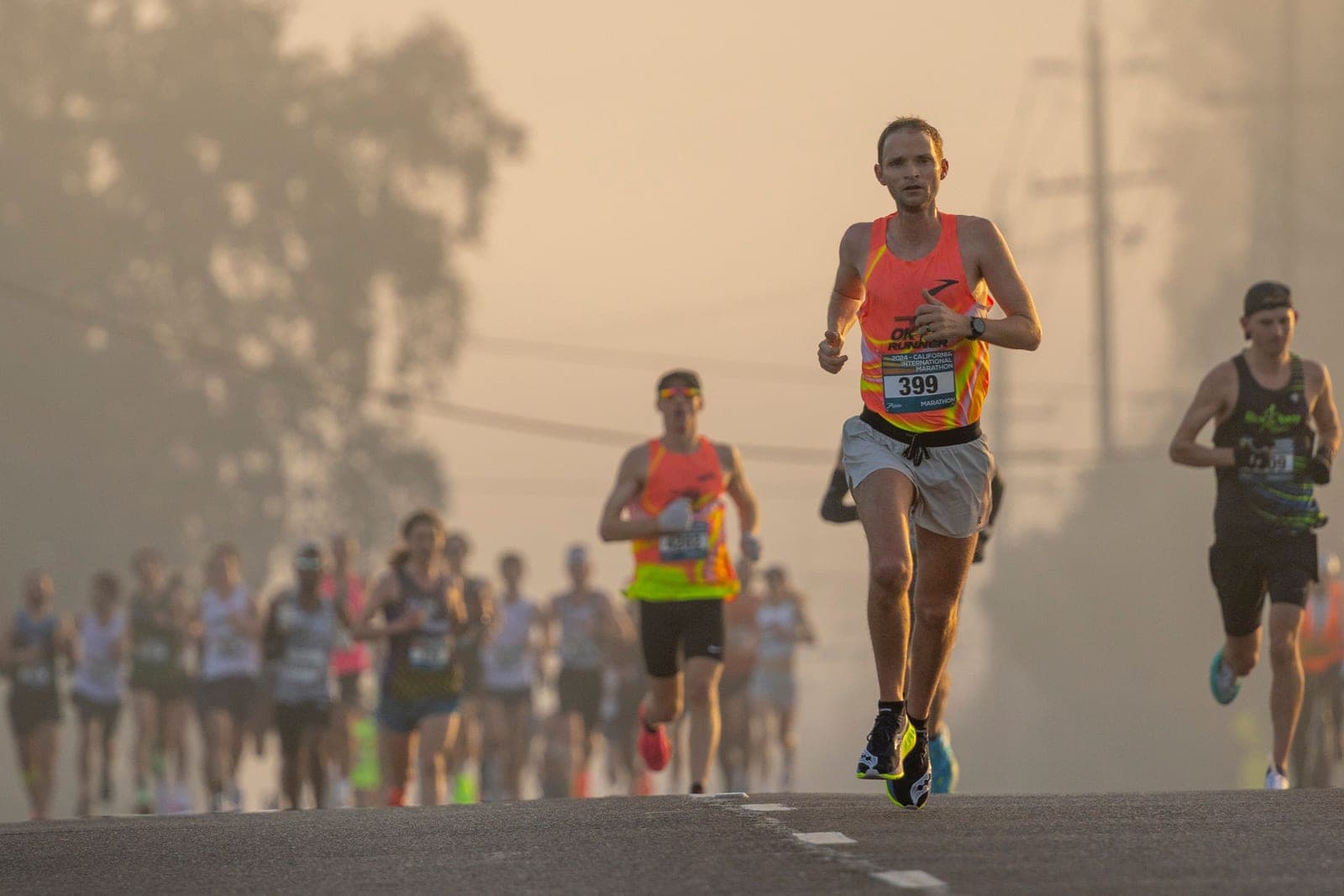A runner on an open road in early morning light