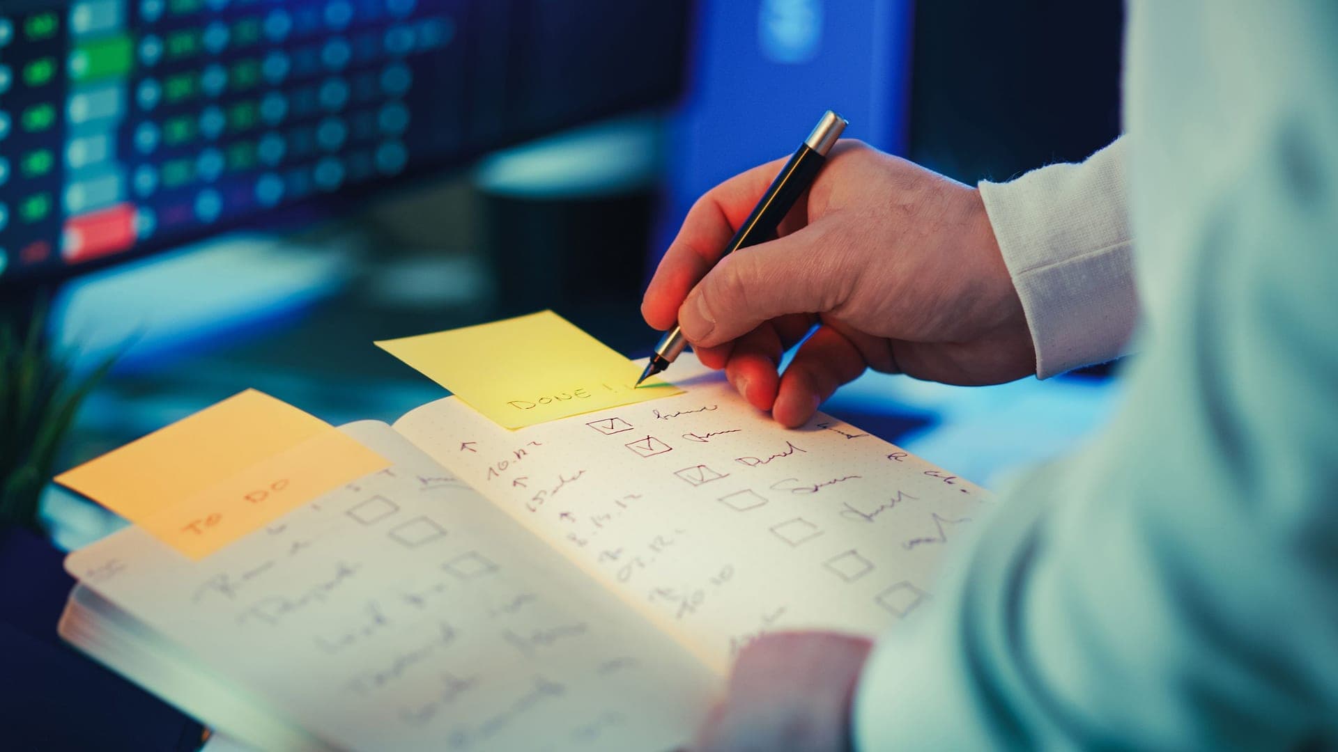 Notes and a checklist laid out on a desk in natural light